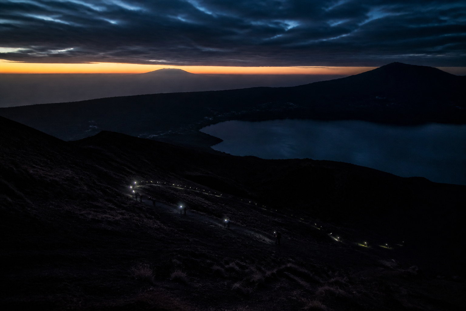 Pickup is around two in the morning. It is genuinely cold at the top and almost nobody packs for it.