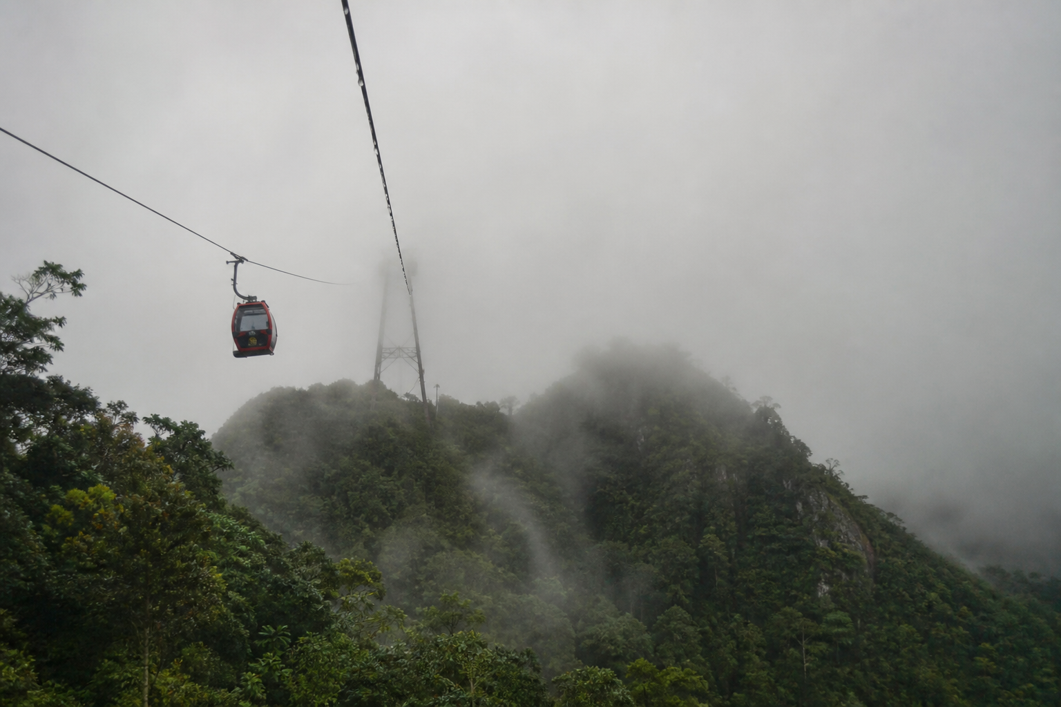 Mist can erase the view without closing the cable car, and you pay either way. Ride early; cloud usually builds over Machinchang by the afternoon.