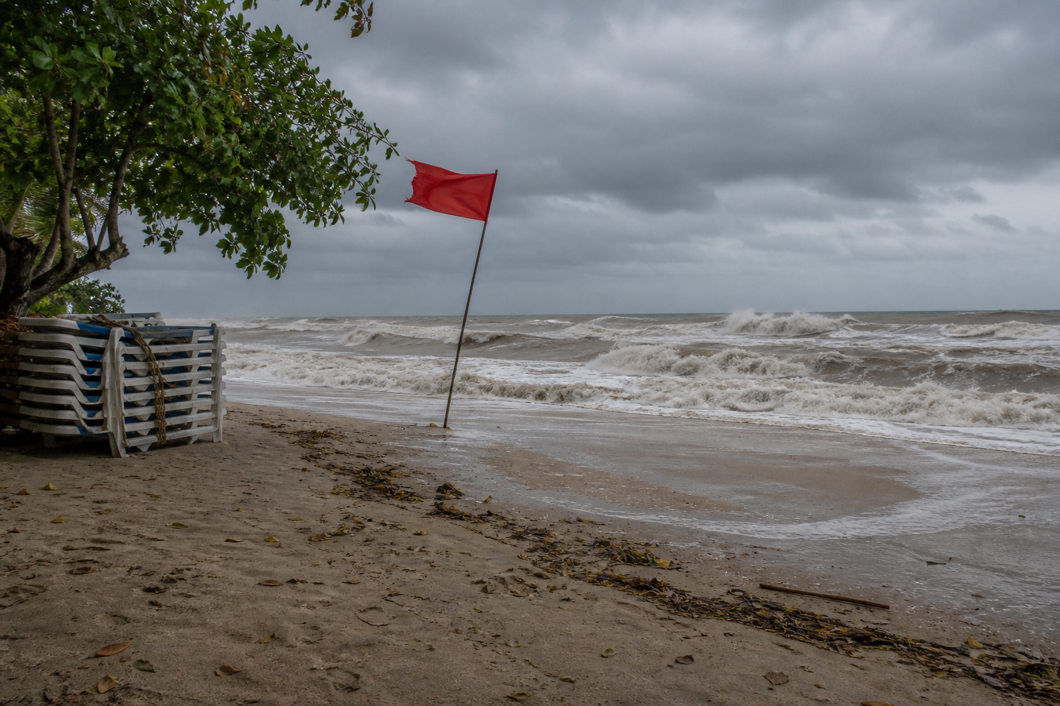 A red flag on a Phuket beach means the water is closed, not that it is risky. Two flags and the lifeguards clear the sand.